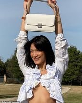 Bella Hadid shows off her toned tummy with a Michael Kors handbag